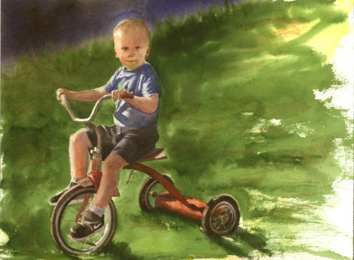 Portrait of a boy riding a tricyle